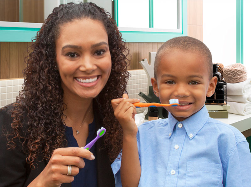 Mother and son brushing their teeth.